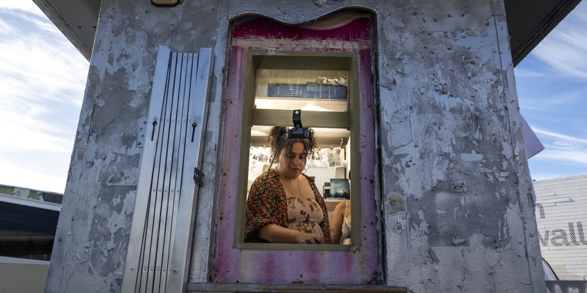person seen through window inside hut