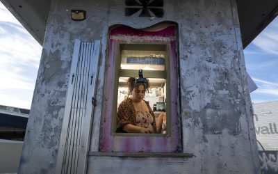 person seen through window inside hut