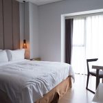 hotel-bedroom-with-double-bed-table-tv-set-scaled.jpg - ReactiveNews